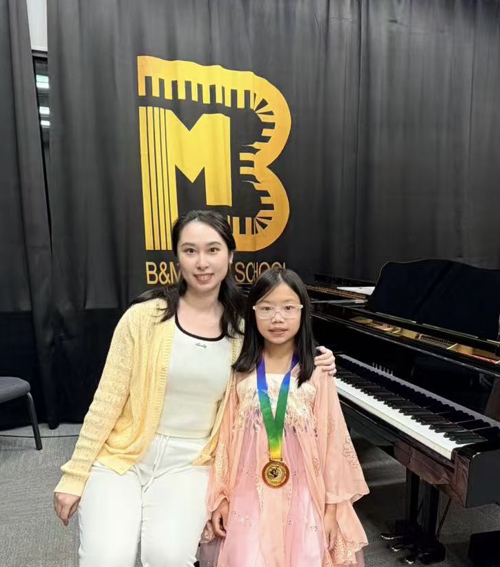 Marina Ma with her teacher, Dr. Xinzhuo Li, at B&M Music School